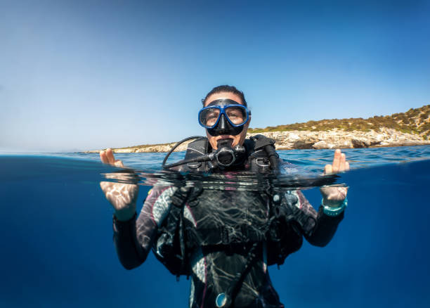 istock Underwater split view of a female scuba diver on the surface 1273471588
