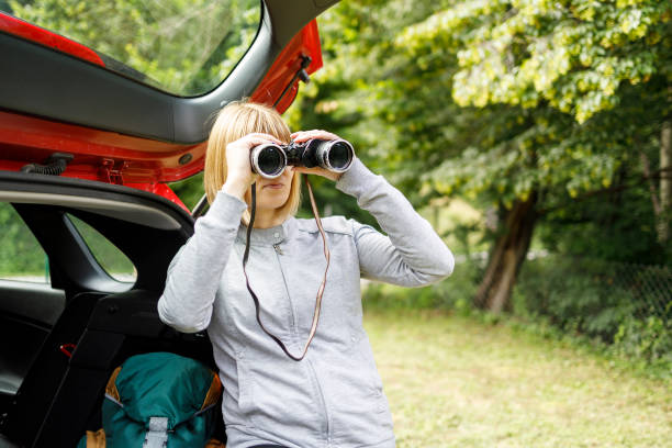 istock Hiker observing wild nature through binoculars before a hike 1273472886