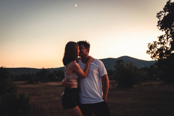 istock Young Couple in Love Kissing in Sunset Light Outdoors 1273473151