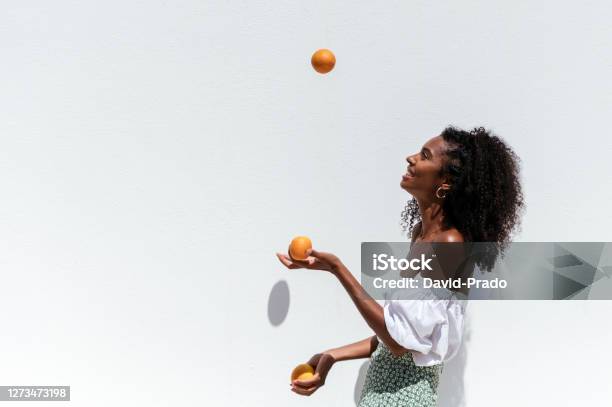 Cheerful Black Woman With Fresh Oranges Stock Photo - Download Image Now - Juggling, One Woman Only, Orange - Fruit