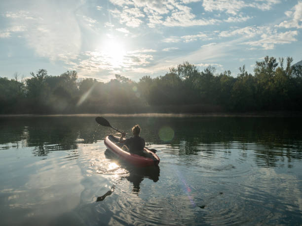 istock Man canoeing on river at sunrise 1273474223