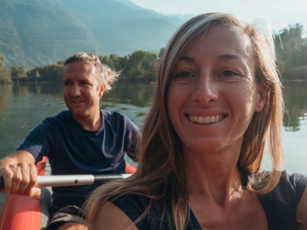 istock Couple take selfie on inflatable canoe in Switzerland 1273474244