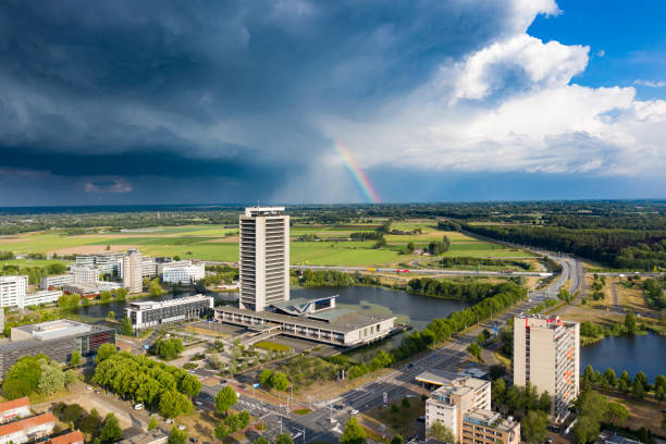 Den Bosch, 8 jun 2020 - The high rise tower skyscraper called provinciehuis with dark clouds and a rainbow in Den Bosch, Brabant, Netherlands. Den Bosch, 8 jun 2020 - The high rise tower skyscraper called provinciehuis with dark clouds and a rainbow in Den Bosch, Brabant, Netherlands. berkel stock pictures, royalty-free photos & images