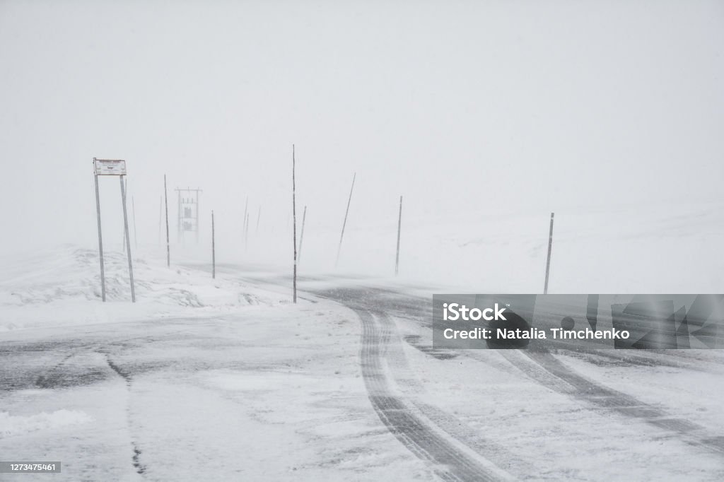 dangerous road snow and blizzard on the winter road landscape. view of the seasonal weather a dangerous road, a winter lonely landscape Squall Stock Photo