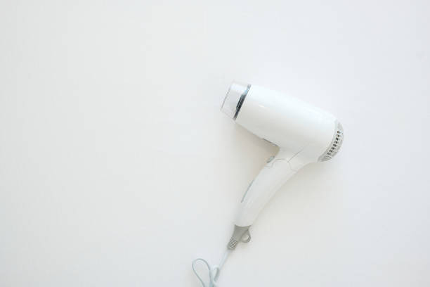 White Hair dryerl on bed at luxury hotel or modern home with copy space for text