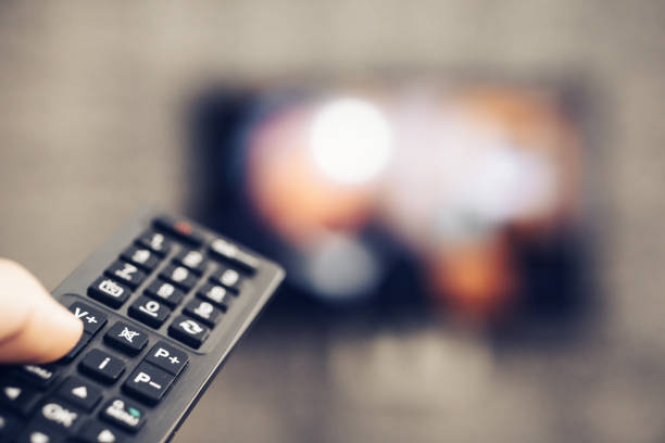 istock watching television with the television remote in hand 1273476640