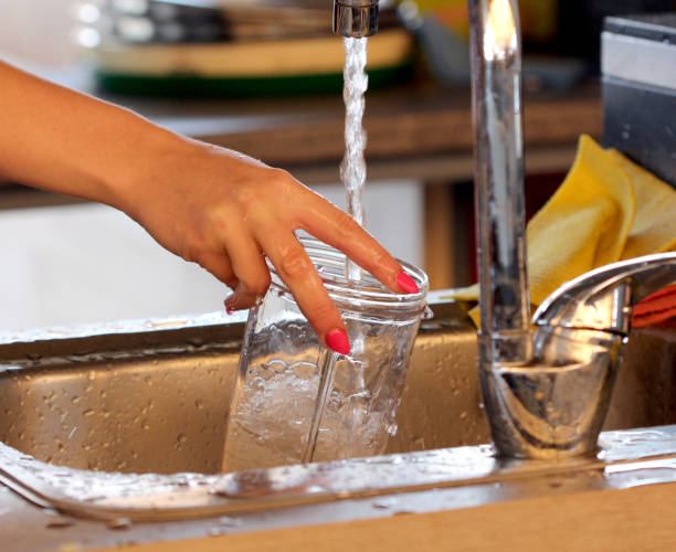 istock close up gesture of hands washing a glass on a sink using detergent and water image 1273476953