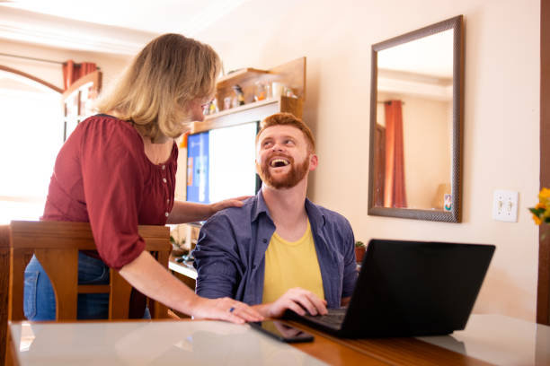istock Mother and son using laptop in the living room 1273477054