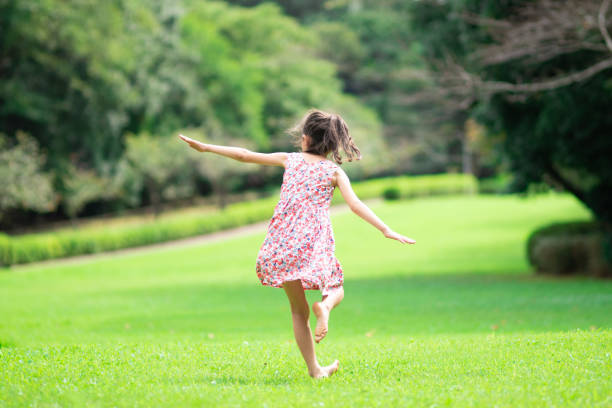 istock Girl playing barefoot on the lawn 1273478254