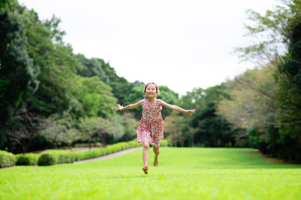 istock Girl playing barefoot on the lawn 1273478265