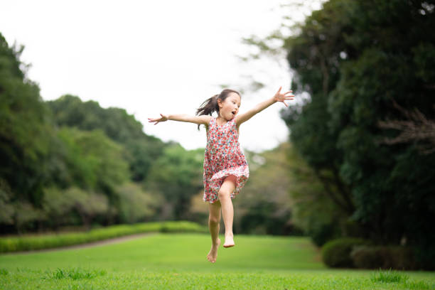 Girl playing barefoot on the lawn