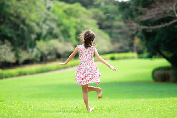 istock Girl playing barefoot on the lawn 1273478278