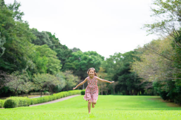 istock Girl playing barefoot on the lawn 1273478280