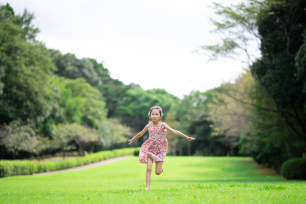 Girl playing barefoot on the lawn