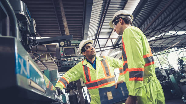 istock Group of factory workers using machine equipment in factory workshop 1273479565