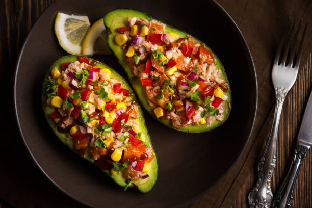 istock Avocado halves stuffed with tuna fish and vegetables 1273479592
