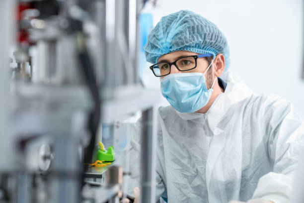 istock Production line worker with face mask working in electronic factory 1273480551