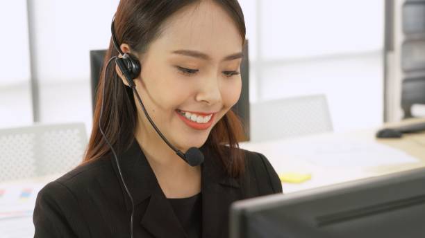 istock Business people wearing headset working in office 1273484275