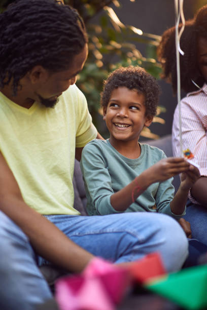 istock young afro-american boy talking with his father, smiling, 1273484397