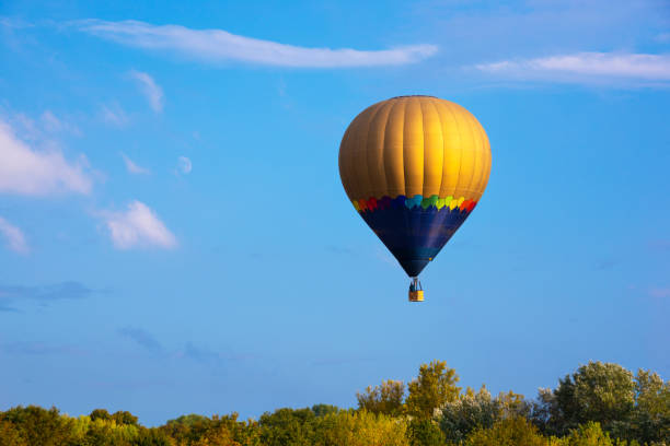 istock Colorful hot air balloon flying in blue sky 1273485698
