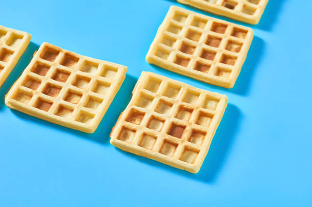 istock Vanilla belgian waffles on blue background 1273487024