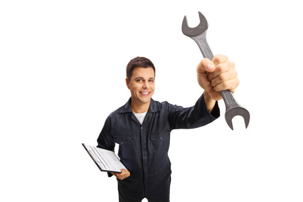 istock Auto mechanic worker with a clipboard holding a key wrench tool 1273488866