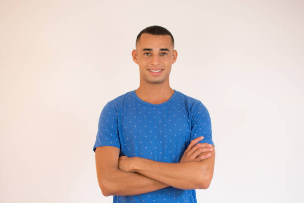istock Handsome young man smiling with arms crossed on white background 1273490209