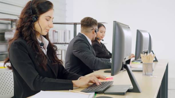 istock Business people wearing headset working in office 1273491214