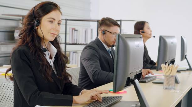 istock Business people wearing headset working in office 1273491989