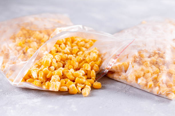 istock Open bag of uncooked frozen corn 1273493327