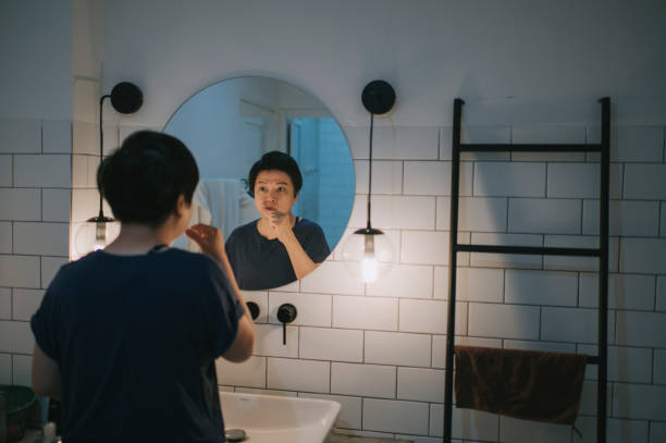 istock asian woman brushing teeth in toilet with mirror reflection 1273494418