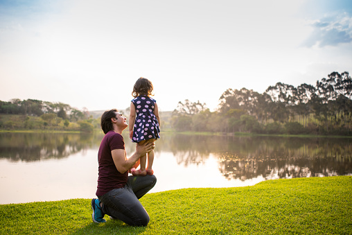 Father and daughter at the lakeside in nature