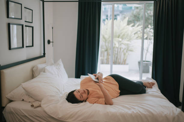 istock asian woman working on home lying on her bed using digital tablet 1273494481