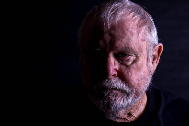 istock Abstract Of Senior Mans Face In Half Light 1273494716