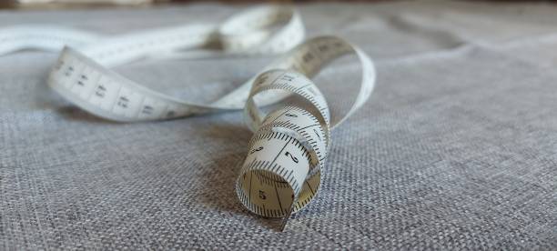 istock Measuring tape for a tailor's work is twisted in a spiral 1273494882
