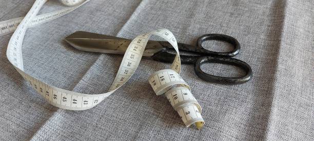 istock Large scissors and measuring tape for a tailor's work 1273495469