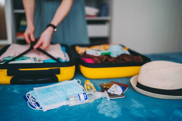 istock Suitcase packing for travel, COVID-19 concept 1273498033