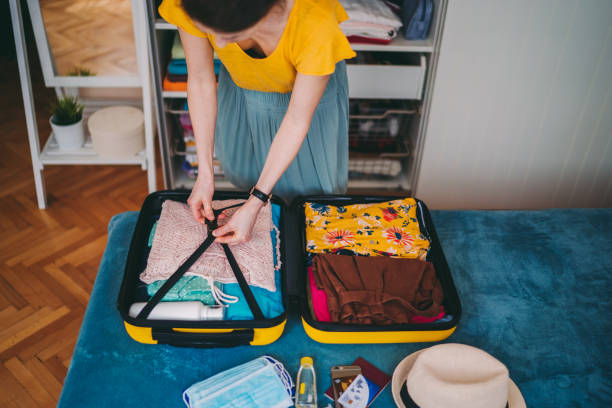 istock Suitcase packing for travel, COVID-19 concept 1273498059