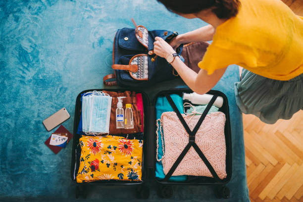 istock Suitcase packing for travel, COVID-19 concept 1273498110