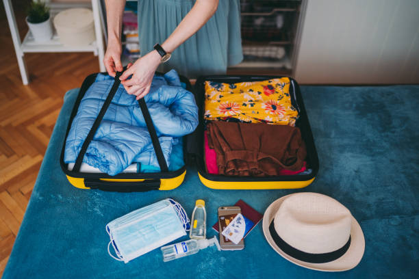 istock Suitcase packing for travel, COVID-19 concept 1273498137