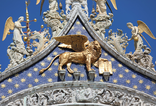 large Lion with wings made of gold on the facade of the Basilica of San Marco in Venice, symbol of the Veneto Region and of the Serenissima Republic