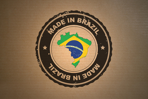 Brown paper with in its middle a retro style stamp Made in Brazil include the map and flag of Brazil.