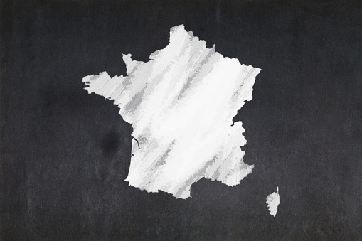Blackboard with a the map of France drawn in the middle.