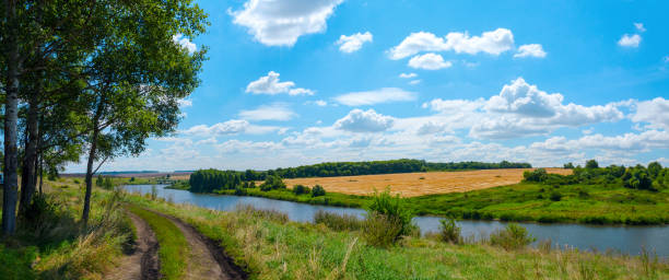 istock Summer landscape with calm river and beautiful clouds in blue sky 1273504624