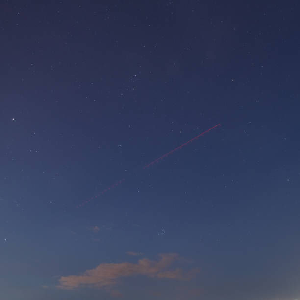 istock Airplane trail in the night sky 1273504785