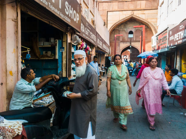 Agra, Uttar Pradesh, India - March 2019: Life in the narrow market streets inside the old Mughal gateways around the Taj Mahal in the old city of Agra.
