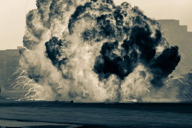 istock Massive fire explosion or strike in military combat and war. Vehicle explosion from a tank in a city in the Middle East. Military Concept. Strength, power, explosion.Black and white 1273508874