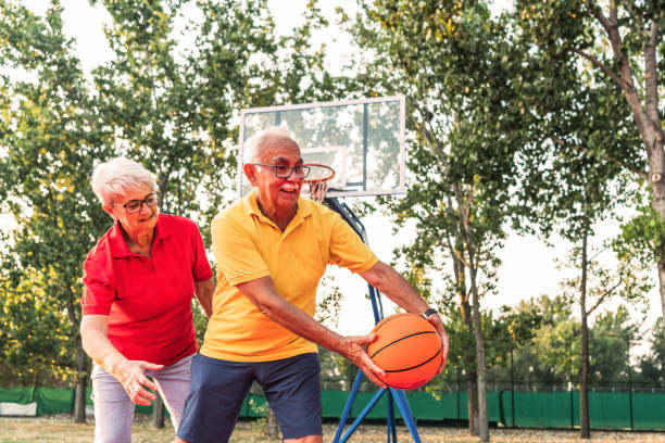 istock Senior couple playing basketball 1273512463