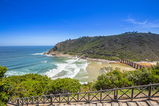 Wilderness Kaaimans river mouth seen from the main N2 road on the garden route of the western cape province in South Africa with a railway line bridge crossing the river mouth.