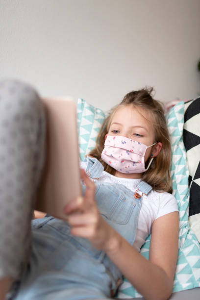 istock Girl Using Mobile Phone On Sofa At Home 1273515474